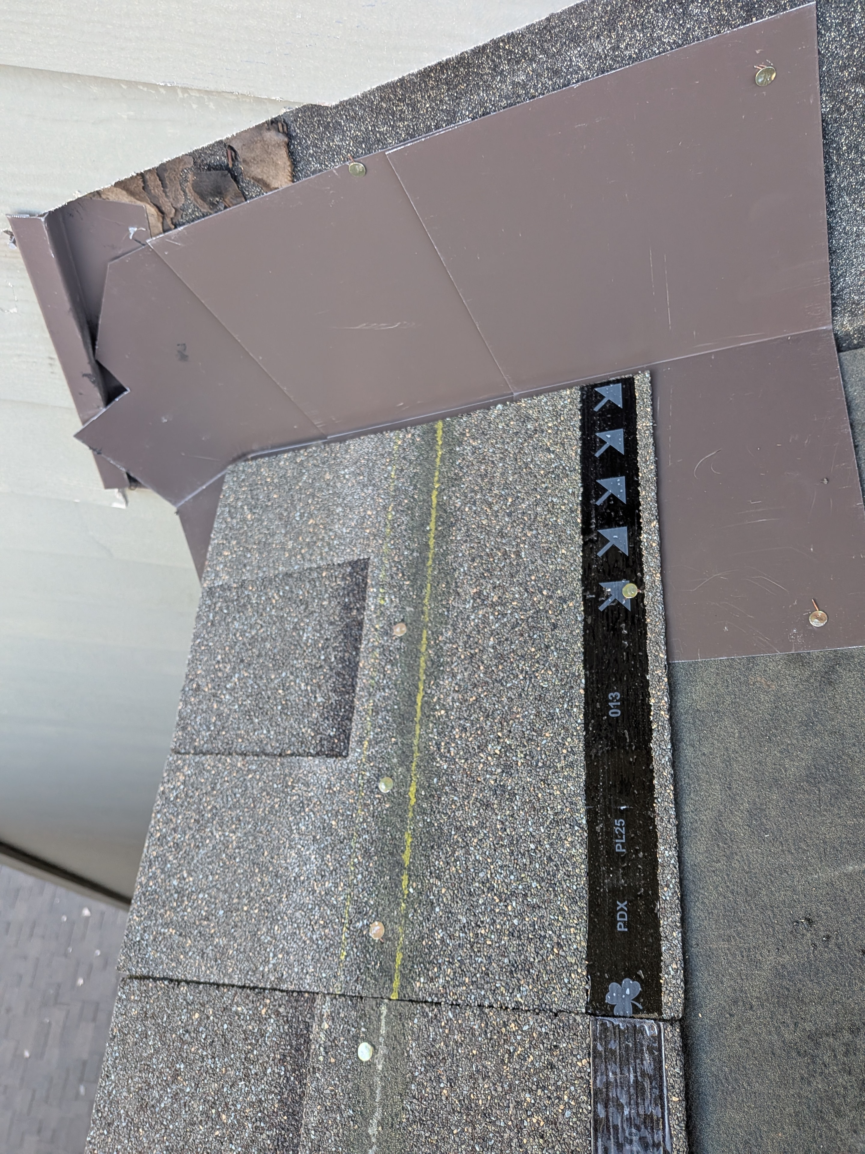 Close-up of roof flashing and drip edge detail with shingles