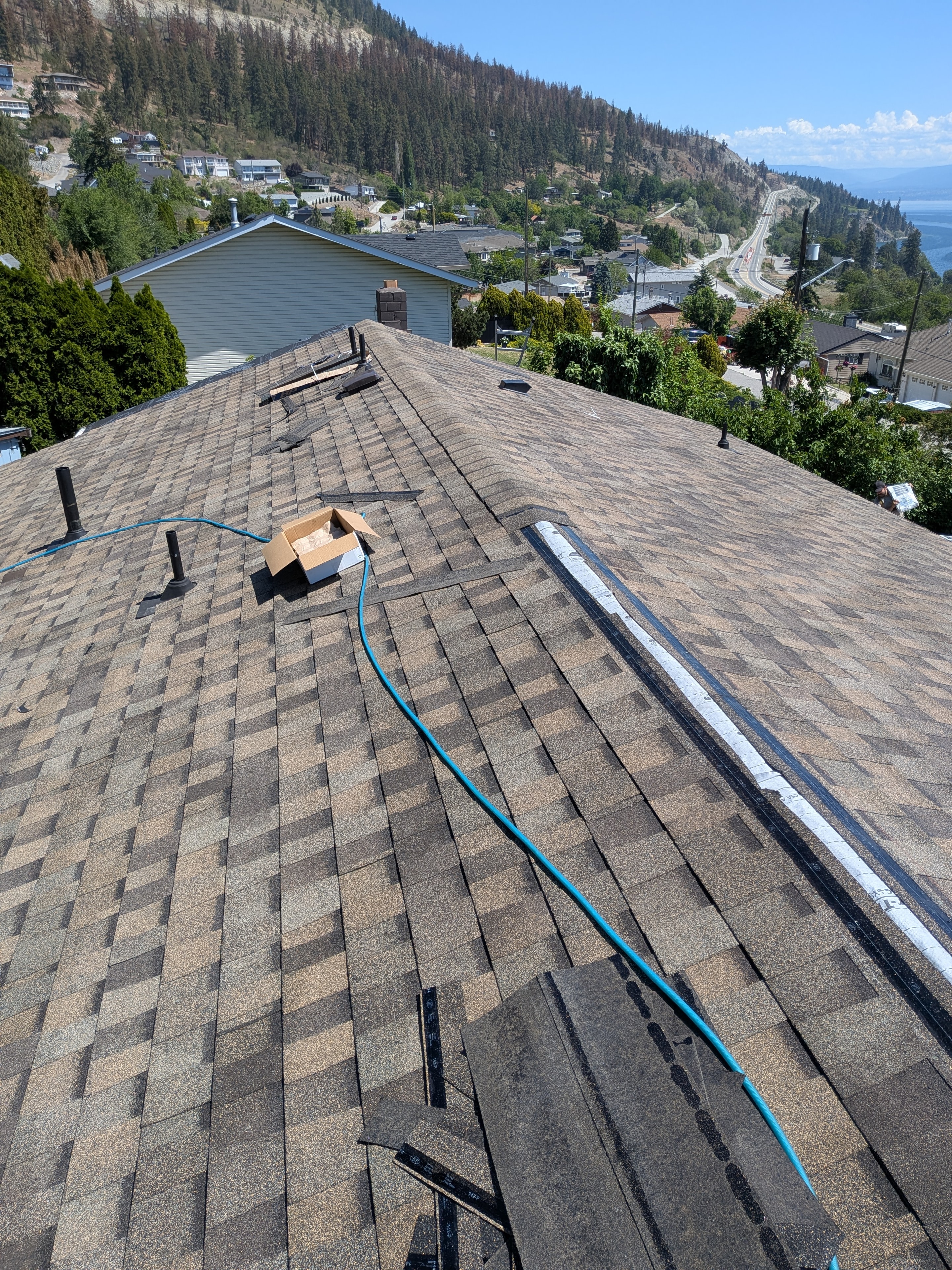 Shingle reroof in progress with Okanagan Lake views from Kelowna hillside home