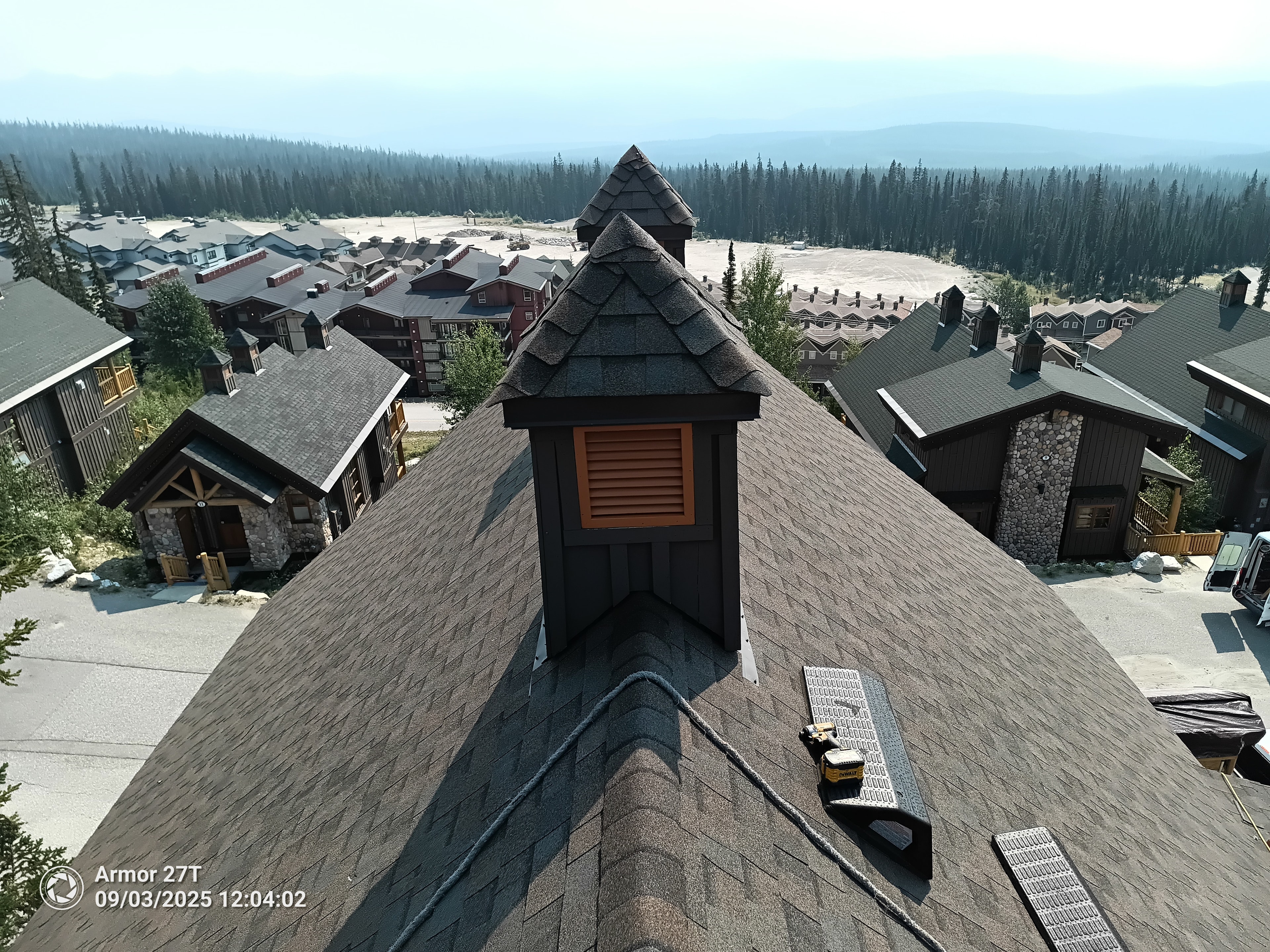 Completed shingle roof on chalet building at Big White with cupola and mountain village views